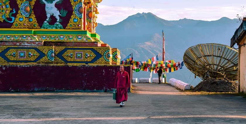 A stunning view of a red and yellow temple with colourful decorations during the day.