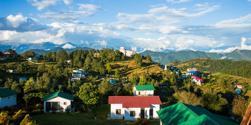 Picturesque view of Uttarakhand mountains viewpoint surrounded by lush greenery.