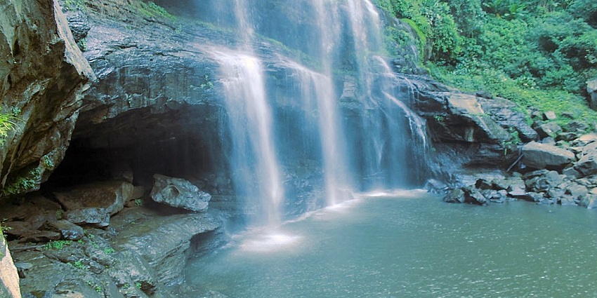 A mesmerising view of Vantawng Falls encircled by lush greenery during the daytime.