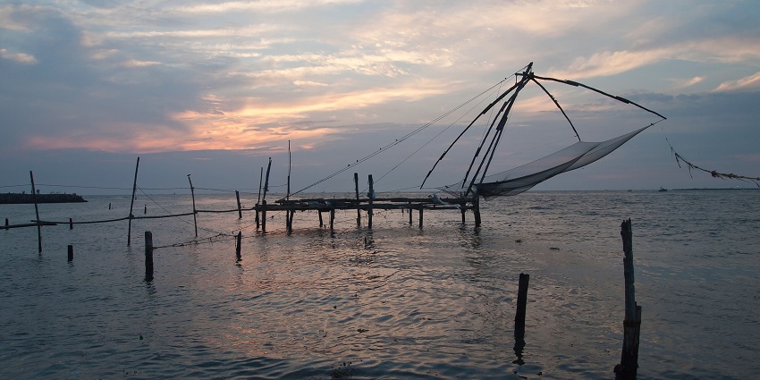Chinese fishing nets in Kochi, Kerala, silhouetted against the sea and evening sky