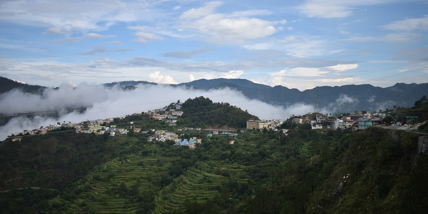 Beautiful view of the green lush hills of Chamba, overlooking the misty mountains far ahead