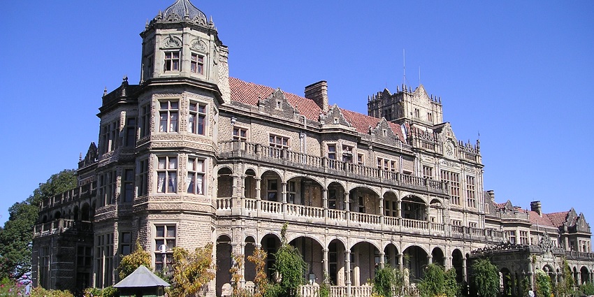 A beautiful colonial-era building surrounded by a big garden