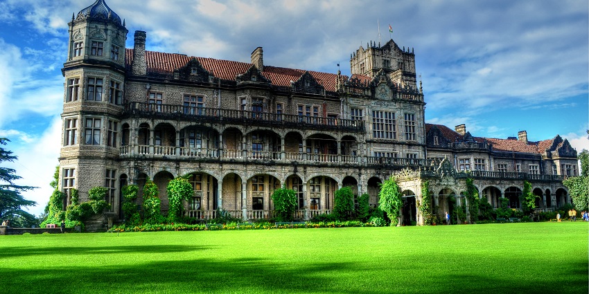 A beautiful colonial-era building surrounded by a big garden