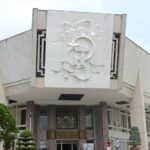 The front view of the museum, a historical marvel, featuring the national flag of Vietnam.