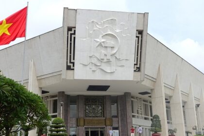 The front view of the museum, a historical marvel, featuring the national flag of Vietnam.