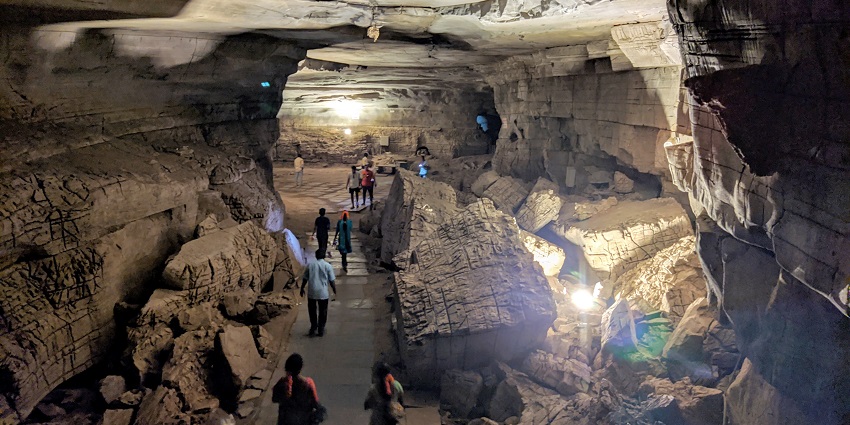 Image of inside Belum caves people exploring the rock formations inside the cave.