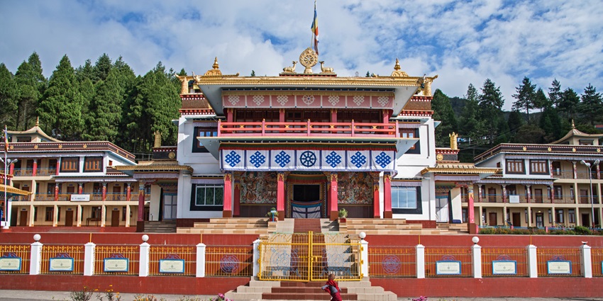 View of monastery, showcasing its intricate architecture surrounded by lush mountains.