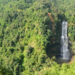 Vantawng Waterfalls cascades down lush green cliffs, creating a stunning natural spectacle.