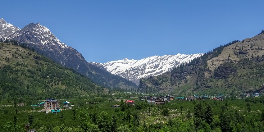 Scenic view of Kullu Valley with lush greenery and mountains near Manali, India.