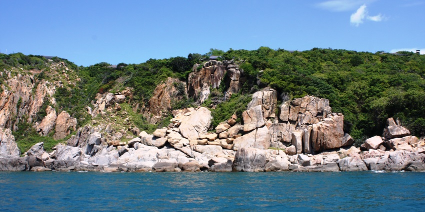 A view of cobalt-blue waters meeting the giant rock cliffs at Vinh Hy in the region.