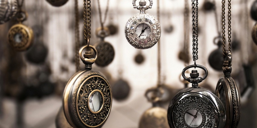  Image of close-up of various silver pocket watches, showcasing intricate details.