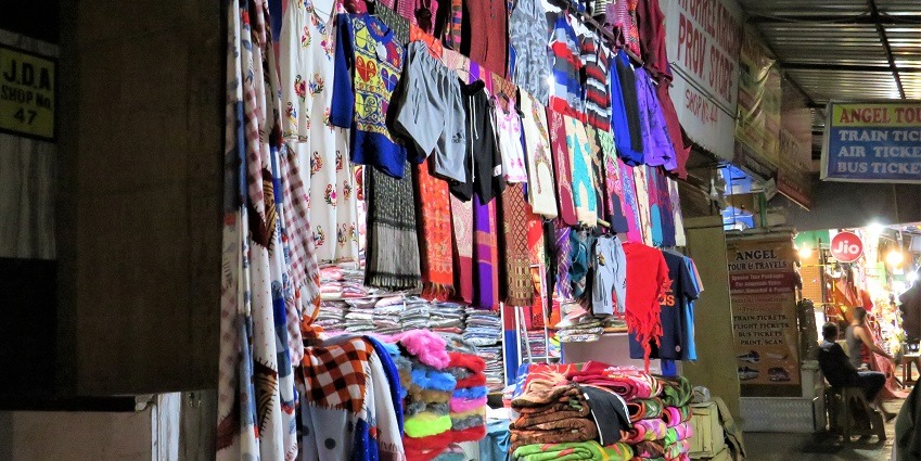 An amazing picture of winter clothes and blankets outside a shop in the Cloth Market