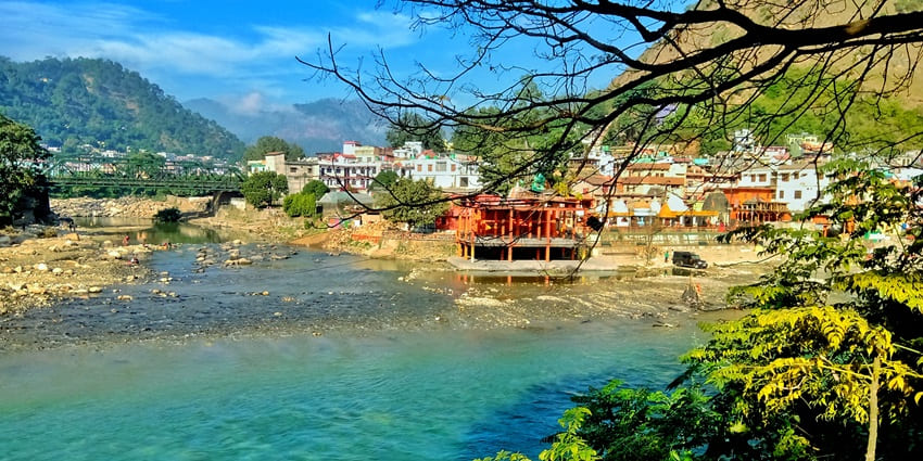 Panoramic image of the beautiful river and settlement on its bank amidst Himalayas