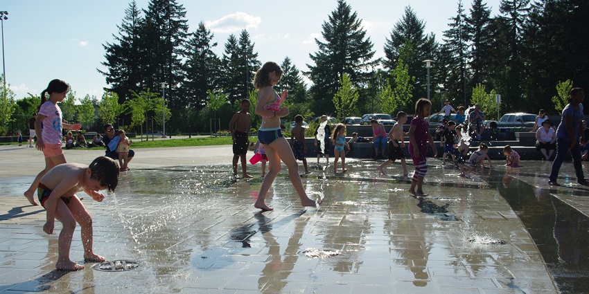Children playing in a park water fountain, the cool sprays - best Singapore water parks