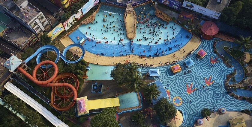 A bird-eye view of a massive water park with multiple slides and swimming pools