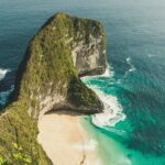 A mesmerising view of a lush green island in the middle of a pristine water body.