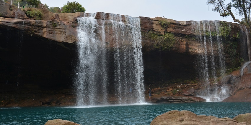 Witness the sparkling water cascading down the rocks into the turquoise river