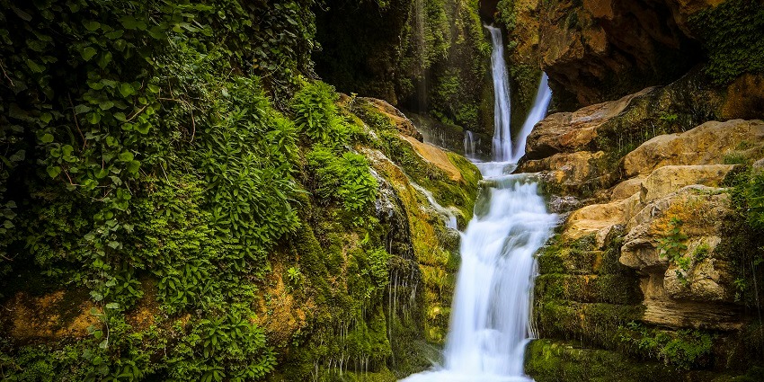 Water cascading down a hill, forming a waterfall