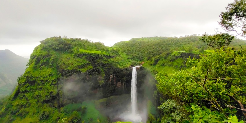 A waterfall surrounded by beautiful greenery