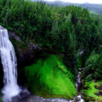 Waterfall cascading through rocks and surrounded by lush greenery - Mizoram waterfalls.