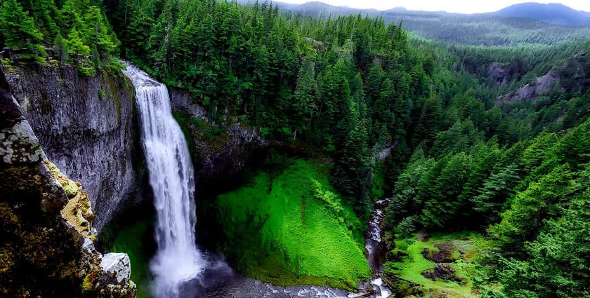 Waterfall cascading through rocks and surrounded by lush greenery - Mizoram waterfalls.