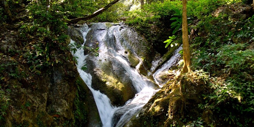 Stunning waterfalls in Kanchanaburi, Thailand, cascading into clear, turquoise pools.