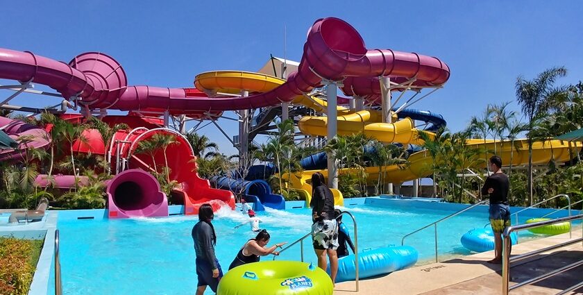 Water park in Thailand, colourful slides, pools, and fun water attractions under a sunny sky.