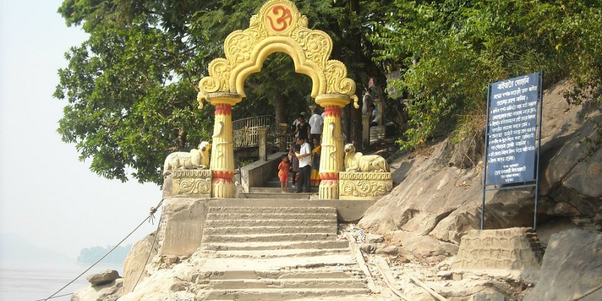 Pathway leading to Umananda Temple with scenic views, steps, and lush surroundings.