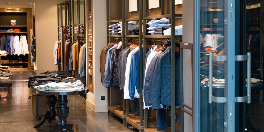 Image of a showroom inside shopping mall - hanging clothes in men section
