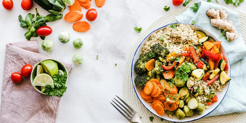 Picture of the mouthwatering salad and green vegetables on a plate placed on table