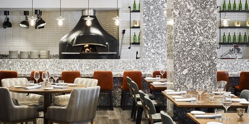 A picture of a restaurant interior with a table setting and cosy ambience having white walls
