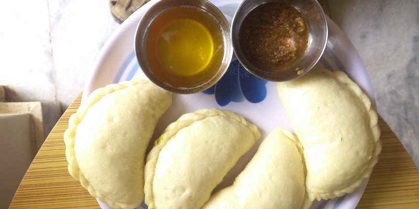 A picture of a traditional dish made in Himachal Pradesh served with different dips