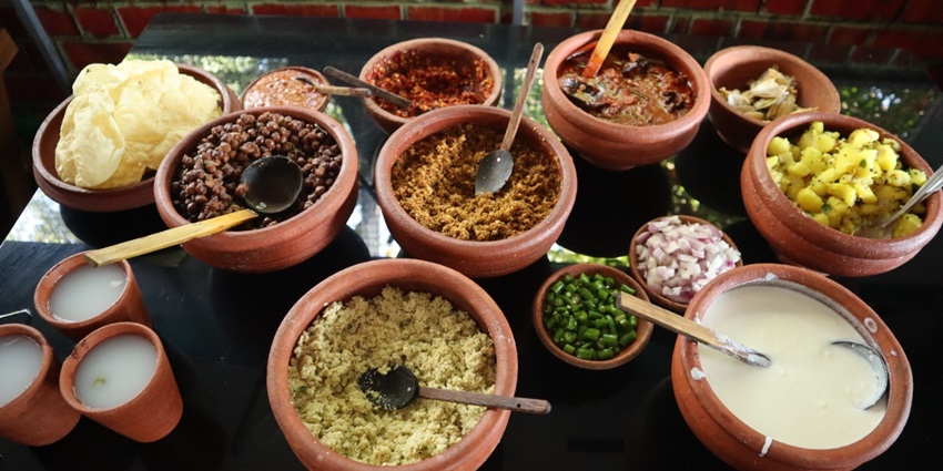 A picture showing various dishes served at a table in a restaurant near the Kerala History Museum