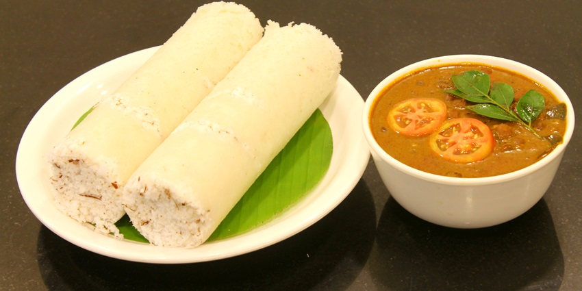 A picture of a traditional food item in Kerala which is a roll made of rice flour and curry