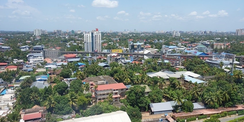 An aerial view of the city showing houses and buildings near the Kerala History Museum
