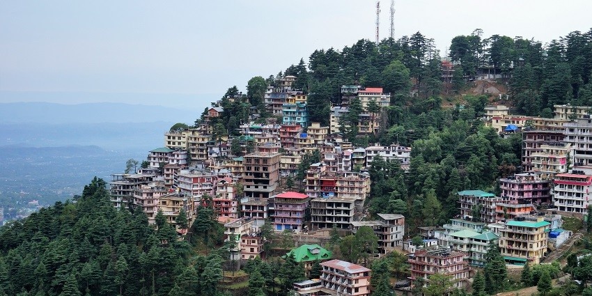 A scenic picture of A hill station with greenery and residential houses