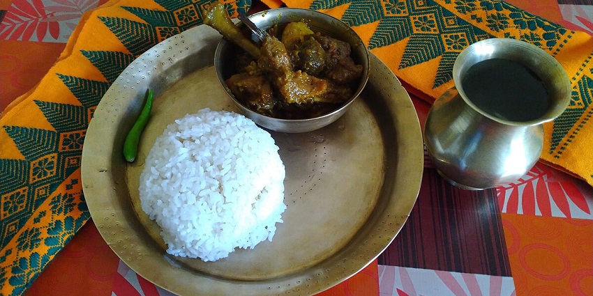 A tempting view of a plate served with steamed rice and a bowl full of cooked meat.