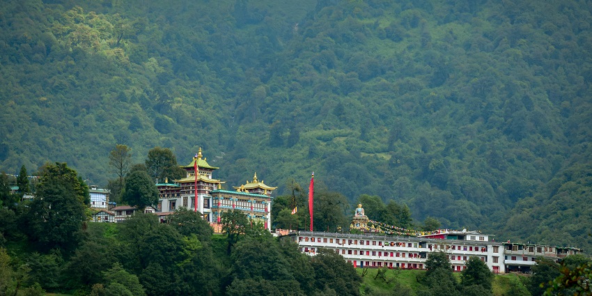 A mesmerising distant view of a monastery in Arunachal Pradesh around lush greenery.