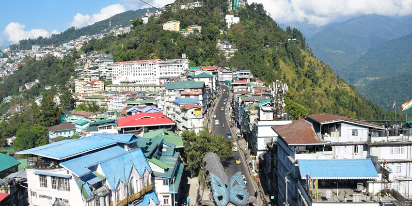 A stunning aerial view of a town with a lot of colourful buildings and a road passing.