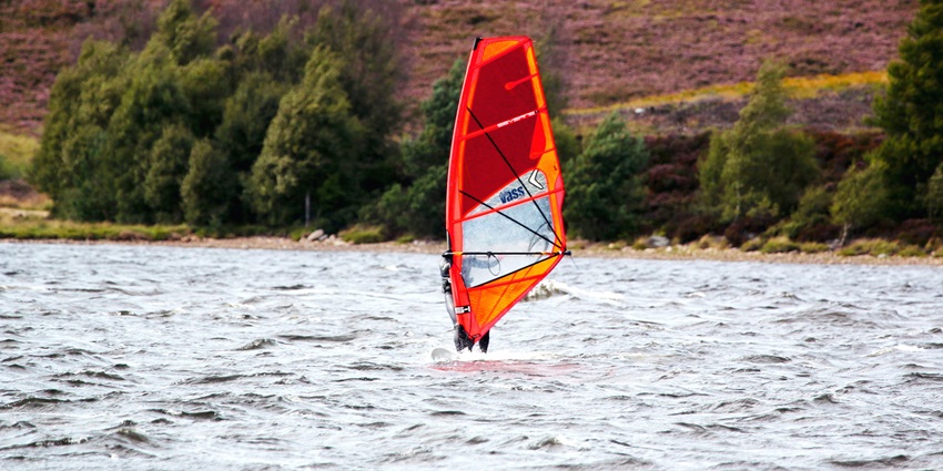 Windsurfing is a combination of both surfing and sailing that makes it a popular activity.
