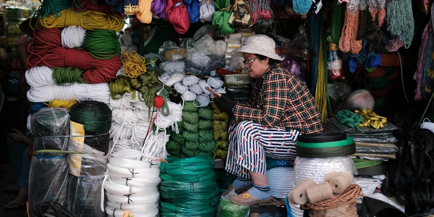 Woman shopkeeper sitting at the counter - places to visit near Shri Govind ji temple in Manipur.