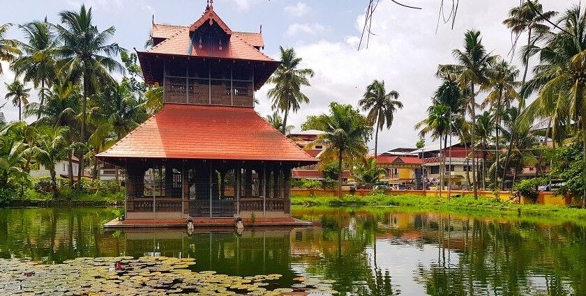 A breathtaking view of a red coloured temple on a body of water during the daytime.