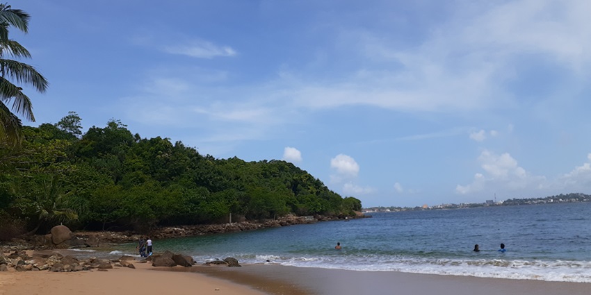Secluded Jungle Beach in Galle with golden sand, calm waters, and dense greenery.