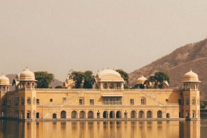 A serene view of a splendid palace surrounded by shimmering waters in Rajasthan.