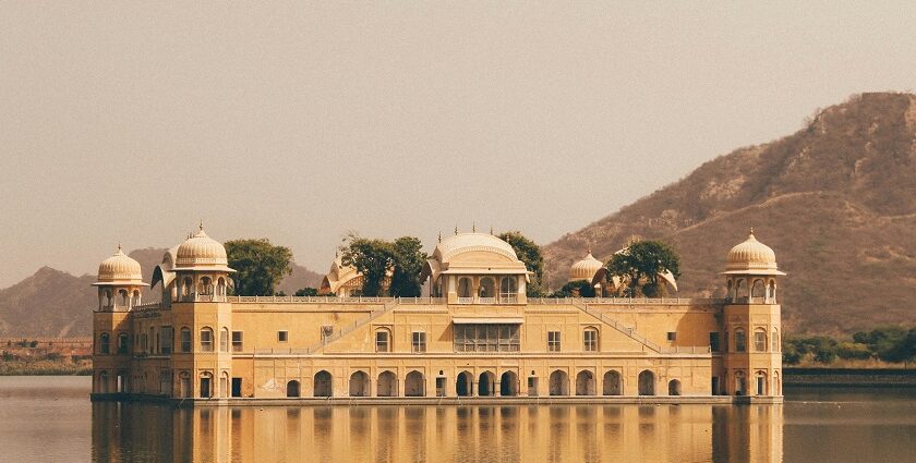 A serene view of a splendid palace surrounded by shimmering waters in Rajasthan.