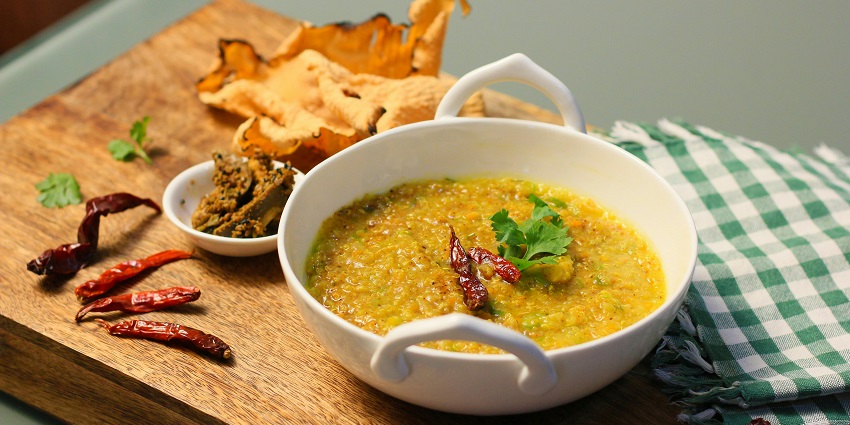 Image of a dish served in a container - Traditional Gujarati thali with an array of local dishes