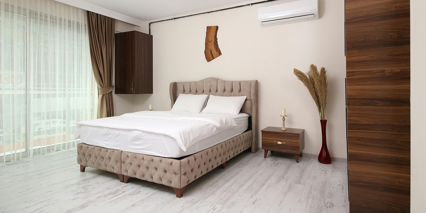 A cosy bedroom featuring a bed, nightstand, and soft lighting for a serene atmosphere.