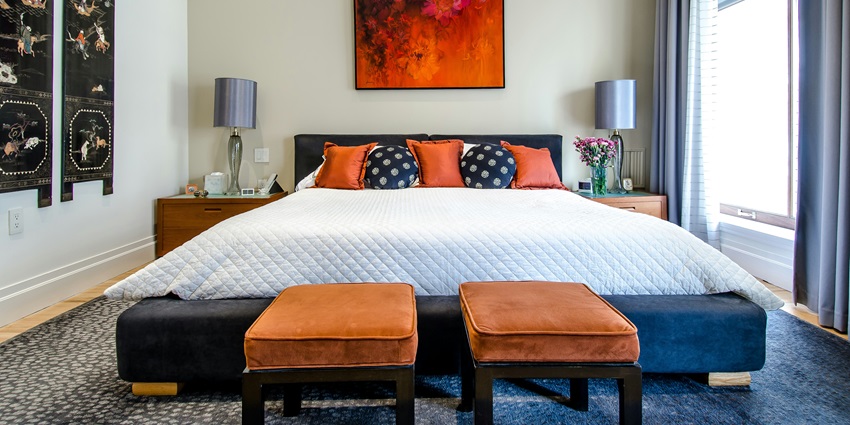 A cosy quilted white comforter draped elegantly over a neatly made bed, inviting relaxation.