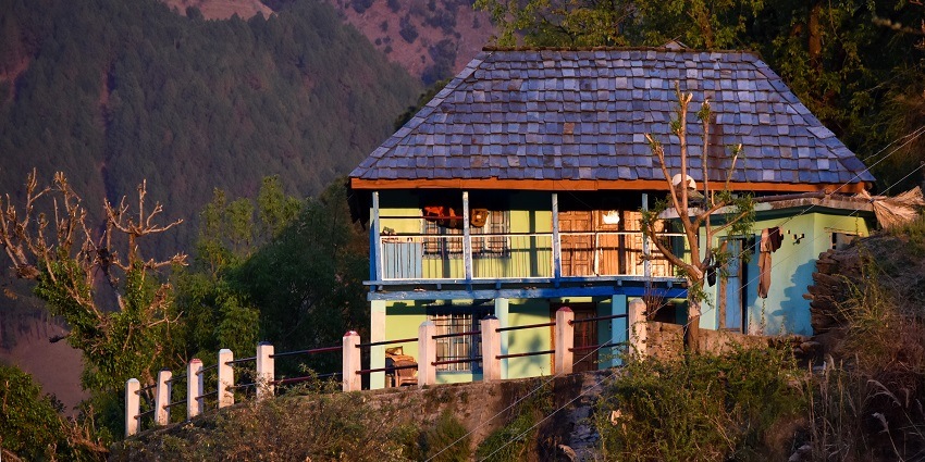 Traditional Arnehar village house bathed in warm setting sunlight, Himachal Pradesh