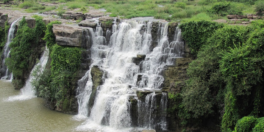 A picture of a waterfall with water slowly cascading down through a series of rocks